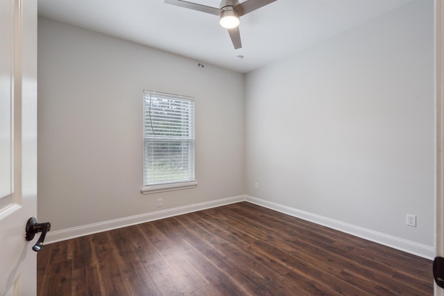 spare room with ceiling fan, baseboards, and dark wood-type flooring