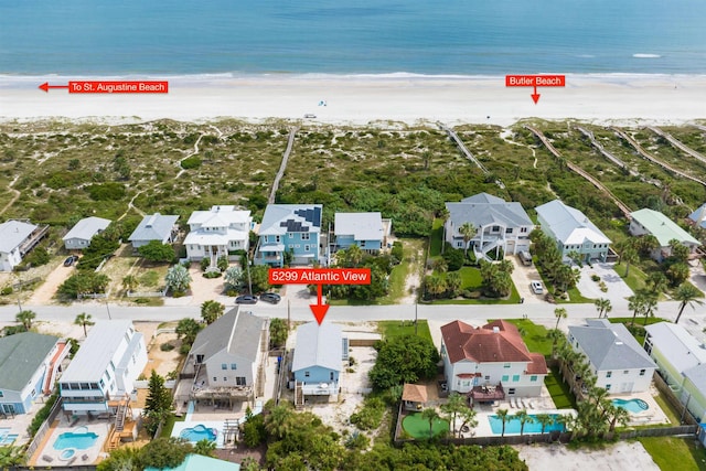 aerial view with a water view and a beach view