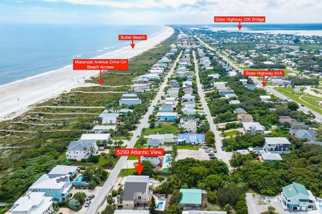 bird's eye view featuring a water view and a view of the beach