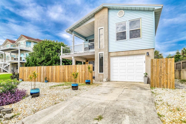 view of front of house featuring a garage and a balcony