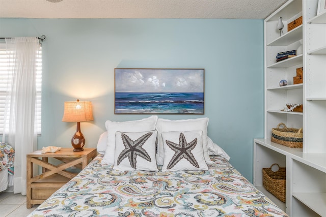 tiled bedroom featuring a textured ceiling