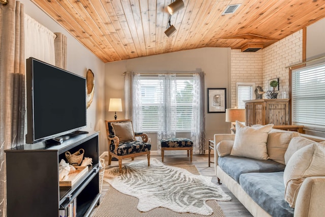 living room featuring wood ceiling, light hardwood / wood-style flooring, and vaulted ceiling