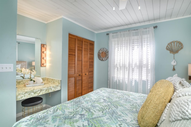 bedroom featuring a closet, wooden ceiling, and ornamental molding