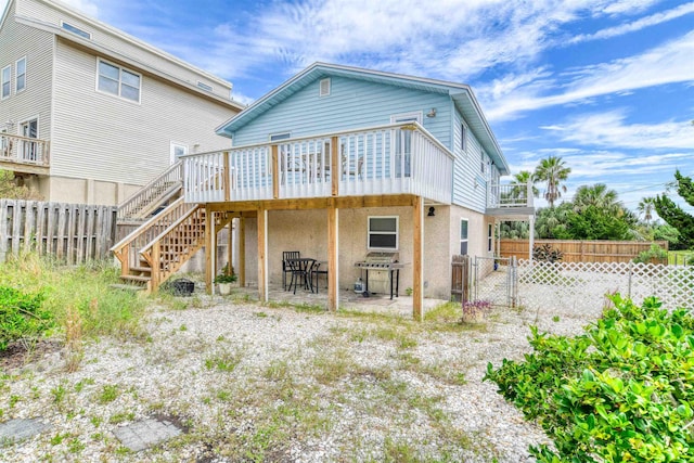 back of house featuring a wooden deck