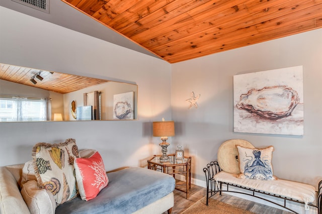 living area with light hardwood / wood-style floors, vaulted ceiling, and wood ceiling