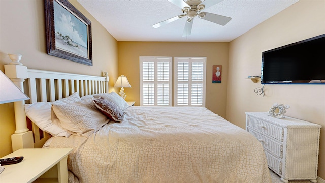 bedroom featuring ceiling fan and a textured ceiling