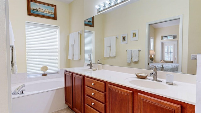 bathroom with vanity, tile patterned floors, and a tub