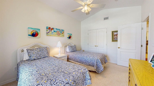 bedroom featuring ceiling fan, light carpet, a closet, and vaulted ceiling