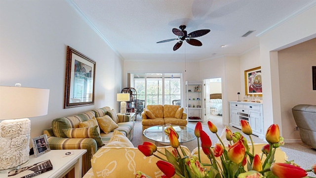 carpeted living room featuring ceiling fan and ornamental molding