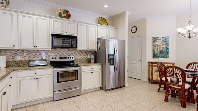 kitchen featuring white cabinets, dark stone countertops, tasteful backsplash, a chandelier, and appliances with stainless steel finishes