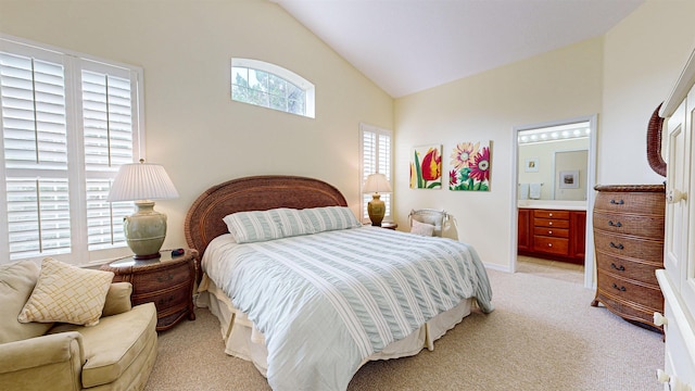 carpeted bedroom featuring multiple windows, connected bathroom, and lofted ceiling