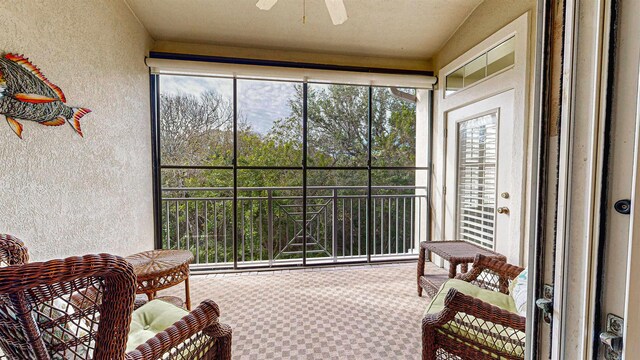 sunroom / solarium featuring ceiling fan and a healthy amount of sunlight