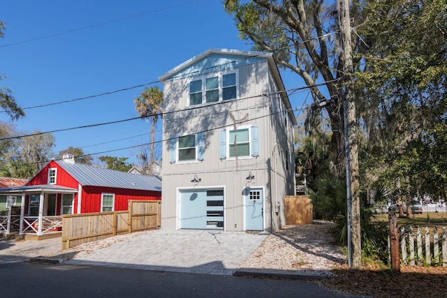 view of front of home featuring an attached garage and decorative driveway