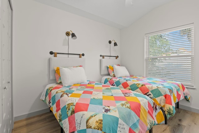 bedroom featuring baseboards, a closet, and wood finished floors