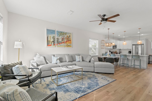 living area with light wood finished floors, visible vents, a ceiling fan, and recessed lighting