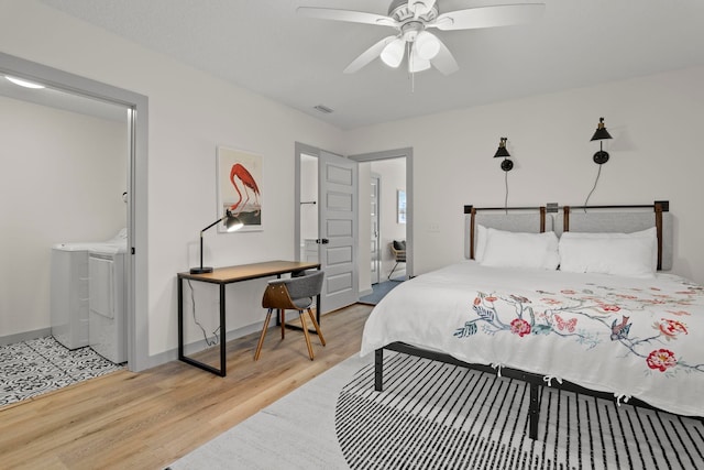bedroom with separate washer and dryer, light wood-style floors, visible vents, ceiling fan, and ensuite bath