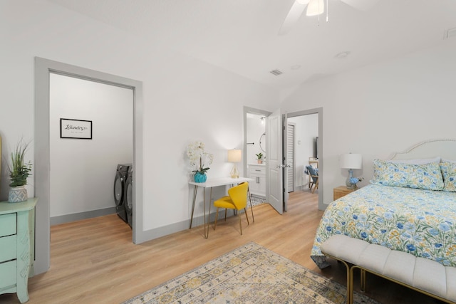 bedroom featuring a ceiling fan, washer and clothes dryer, light wood-style flooring, and baseboards