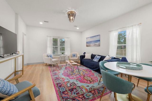 living room with recessed lighting, visible vents, and light wood-style floors