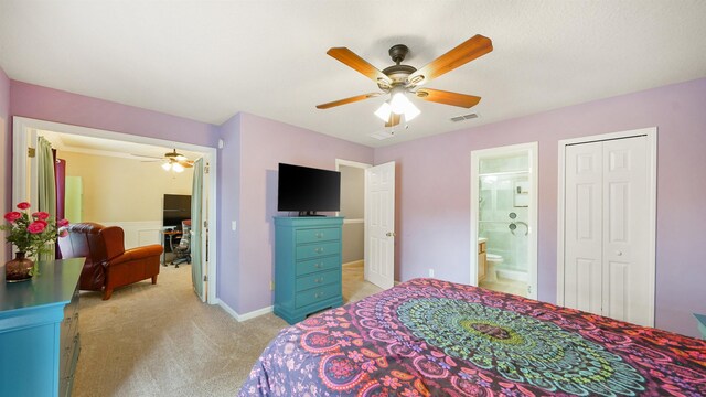 carpeted bedroom with a closet, ceiling fan, and ensuite bathroom