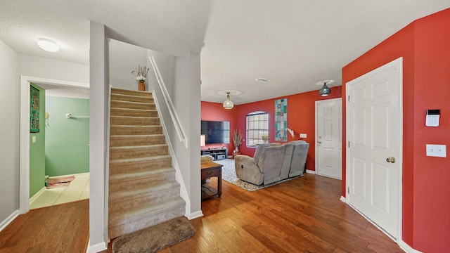 interior space with hardwood / wood-style floors and a textured ceiling