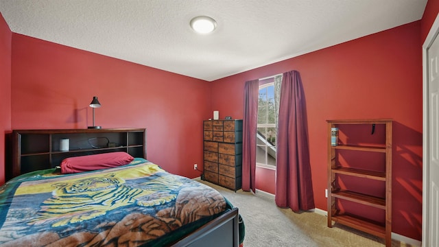 bedroom with light colored carpet and a textured ceiling