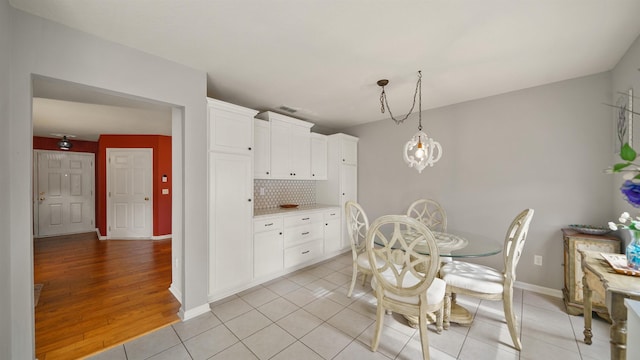 dining space featuring an inviting chandelier and light tile patterned floors