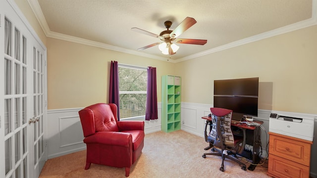 carpeted home office featuring a textured ceiling, ornamental molding, and ceiling fan