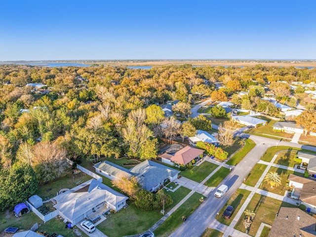 drone / aerial view featuring a residential view and a forest view