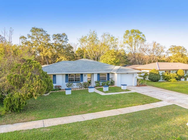 ranch-style house with a garage, driveway, and a front lawn