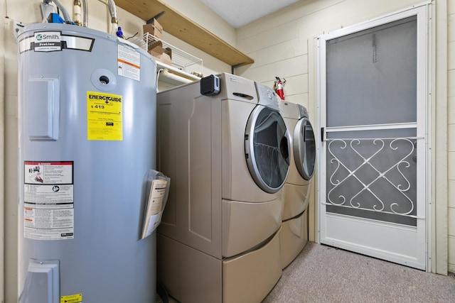 washroom with water heater, laundry area, and washing machine and dryer