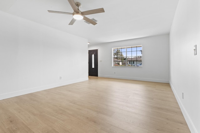 unfurnished room featuring light wood finished floors, a ceiling fan, and baseboards