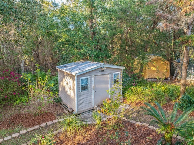 view of shed with a forest view