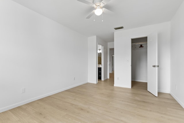 unfurnished bedroom with baseboards, visible vents, connected bathroom, and light wood finished floors