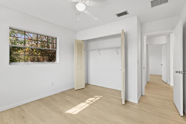 unfurnished bedroom featuring a closet, light wood-type flooring, visible vents, and baseboards