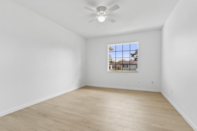 unfurnished room with a ceiling fan, light wood-style flooring, and baseboards