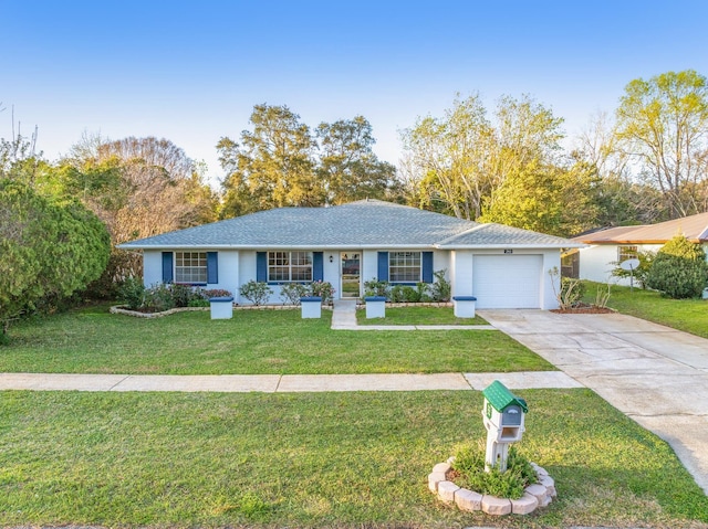 ranch-style house featuring a garage, driveway, and a front lawn