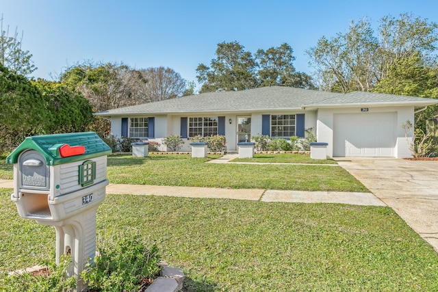 ranch-style house with driveway, a shingled roof, a garage, and a front yard