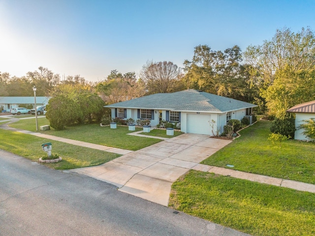 single story home with a garage, driveway, and a front lawn