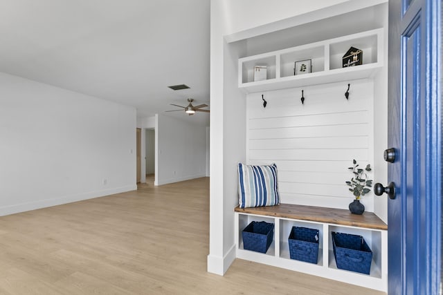 mudroom with baseboards, a ceiling fan, visible vents, and light wood-style floors