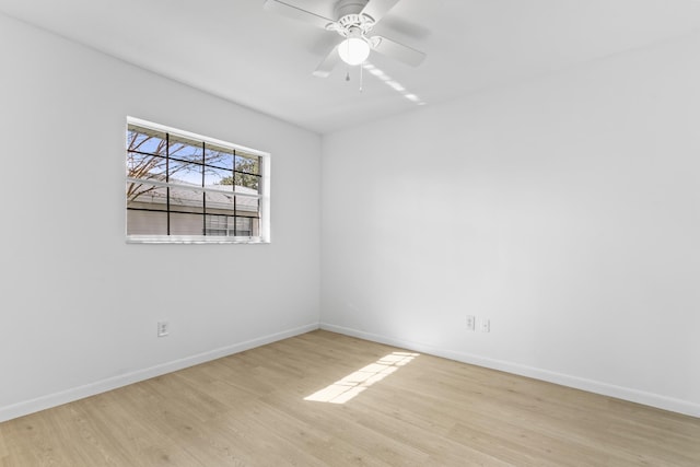 spare room with light wood-style flooring, baseboards, and ceiling fan