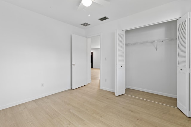 unfurnished bedroom featuring baseboards, visible vents, and light wood finished floors