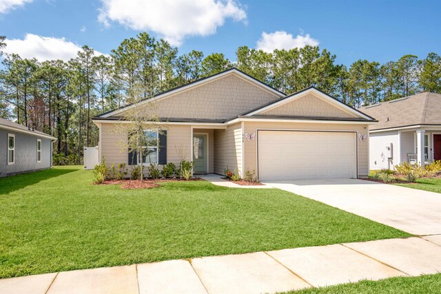 ranch-style home with a front yard, concrete driveway, and an attached garage