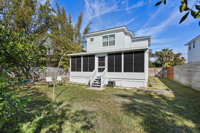 back of property featuring a yard and a sunroom