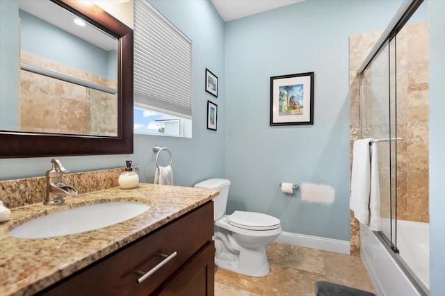 full bathroom with enclosed tub / shower combo, vanity, and toilet