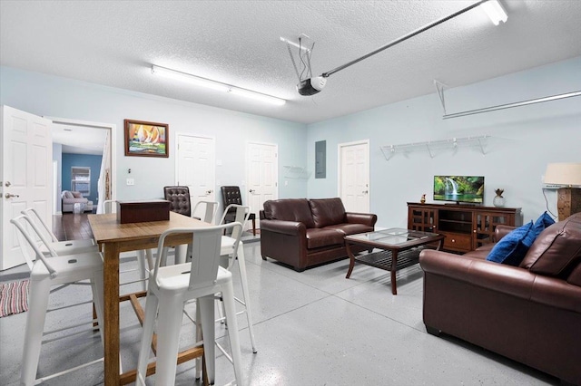 living room featuring electric panel and a textured ceiling