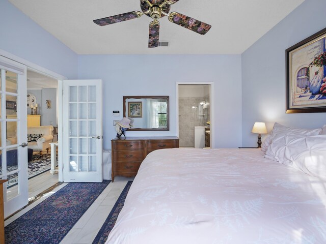 84 Seascape Cir, Saint Augustine, FL 32080 - tiled bedroom featuring french doors, ensuite bathroom, and ceiling fan