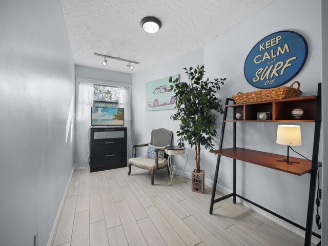 84 Seascape Cir, Saint Augustine, FL 32080 - living area featuring baseboards, a textured ceiling, and wood finished floors