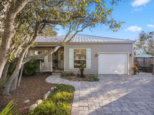 84 Seascape Cir, Saint Augustine, FL 32080 - ranch-style home with an attached garage, decorative driveway, and metal roof
