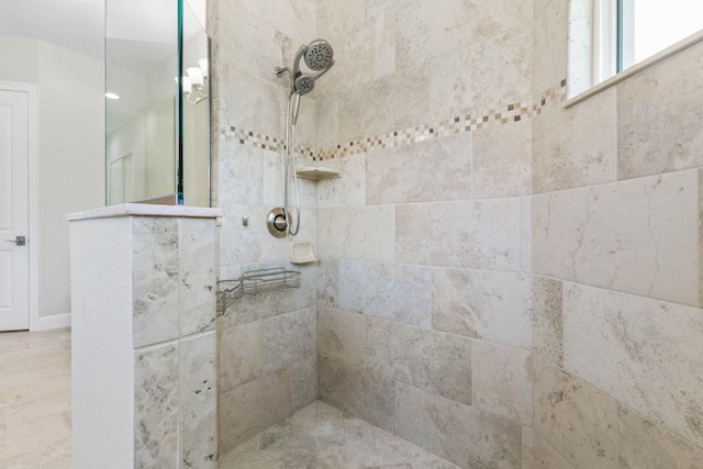 bathroom with tiled shower