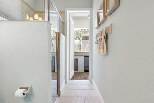 hall featuring light tile patterned flooring